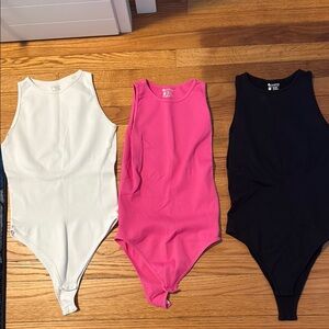 White, Pink, and Black bodysuits Size M